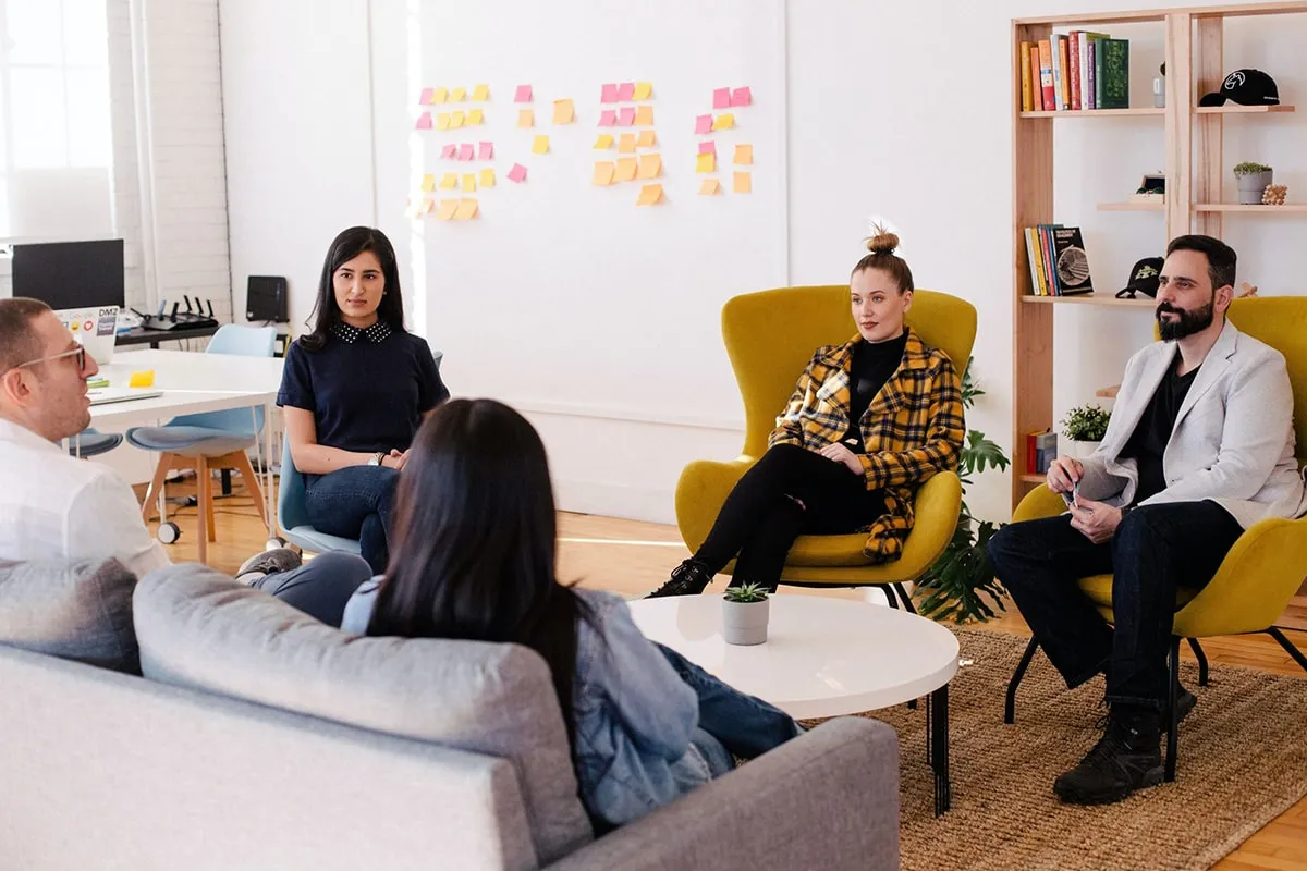 a group of coworkers sitting together having a discussion