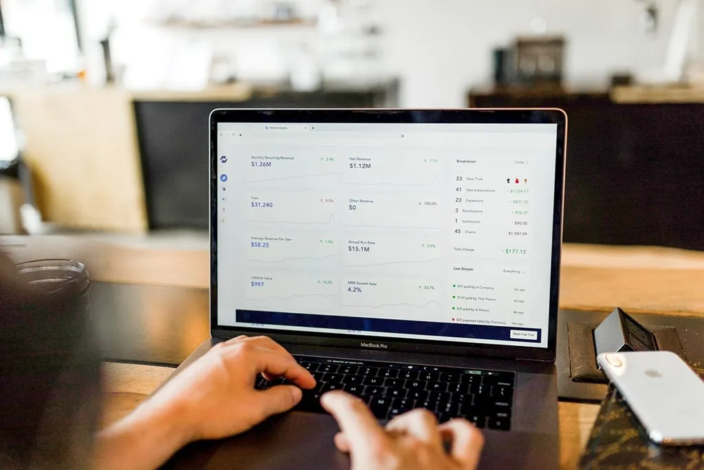 A person working on a laptop at a table while browsing Technical SEO services.