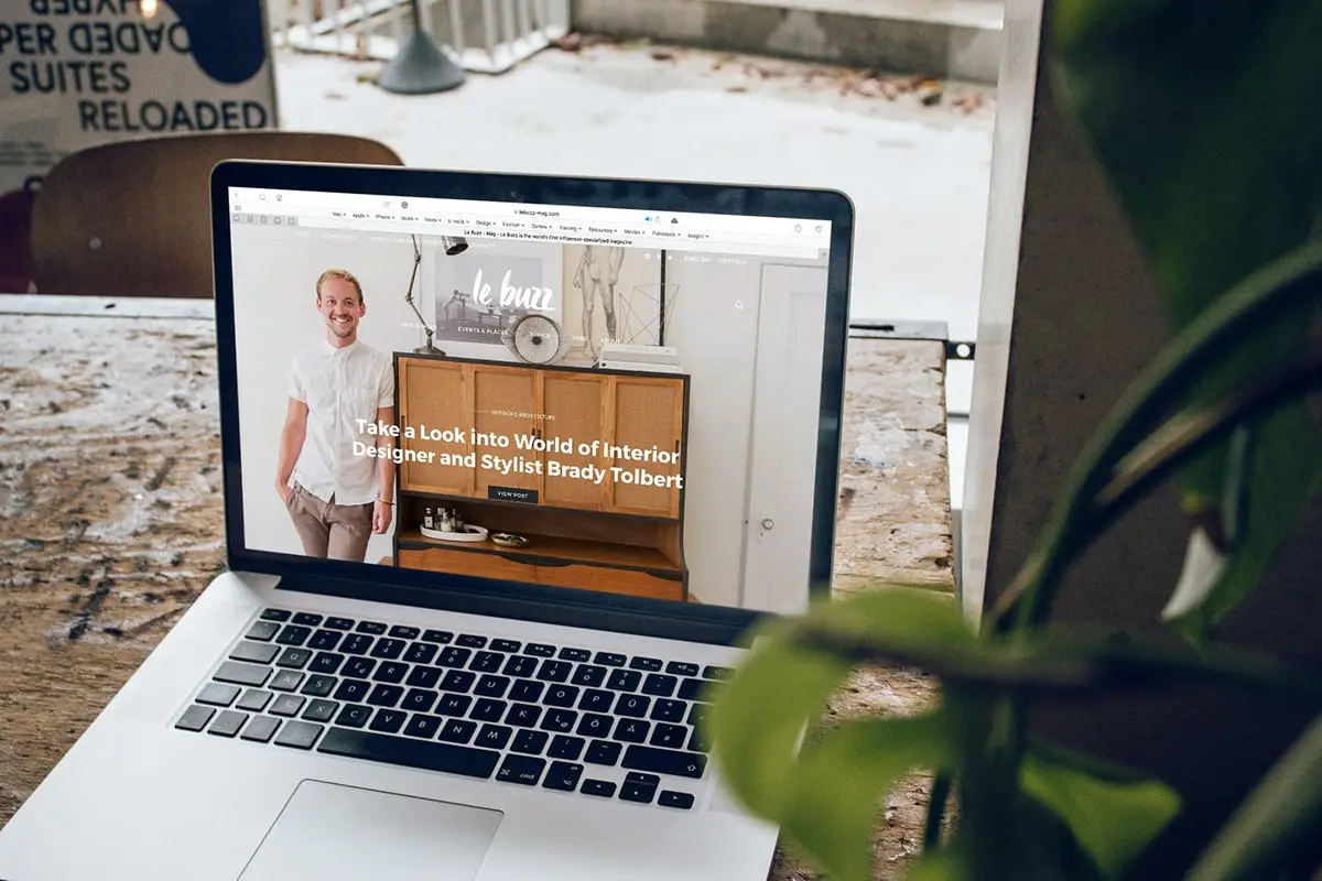 A photo of a laptop with a homepage to an interior designer