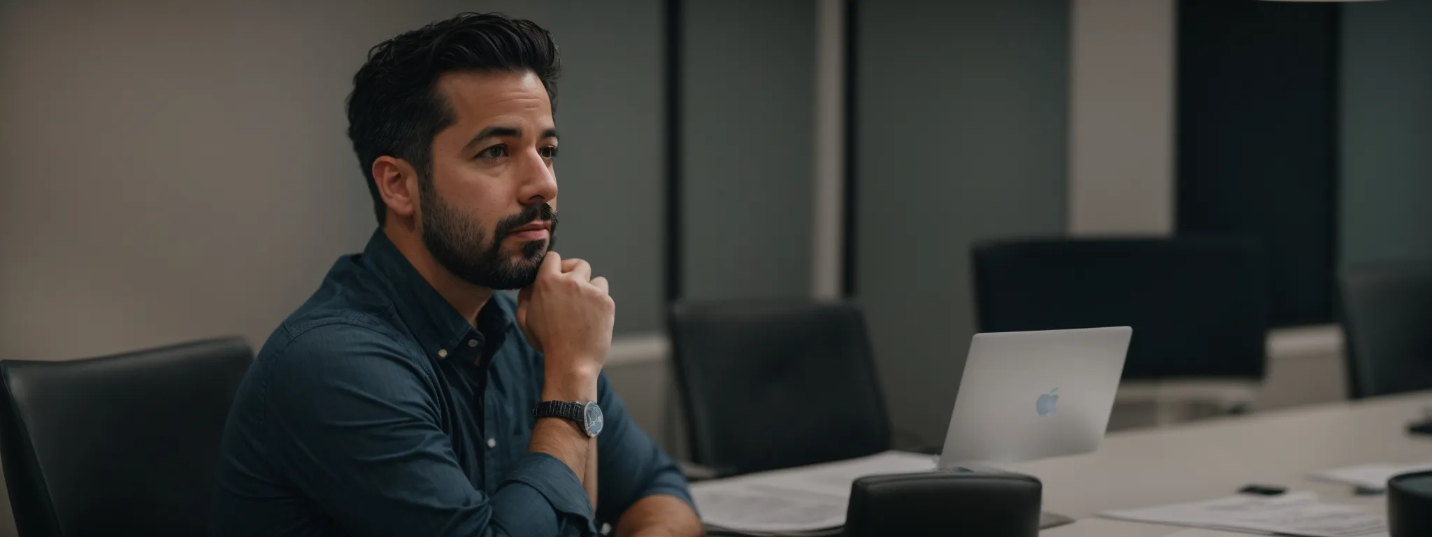a thoughtful rand fishkin in a conference room, discussing charts and graphs on a screen about seomoz's strategic planning.