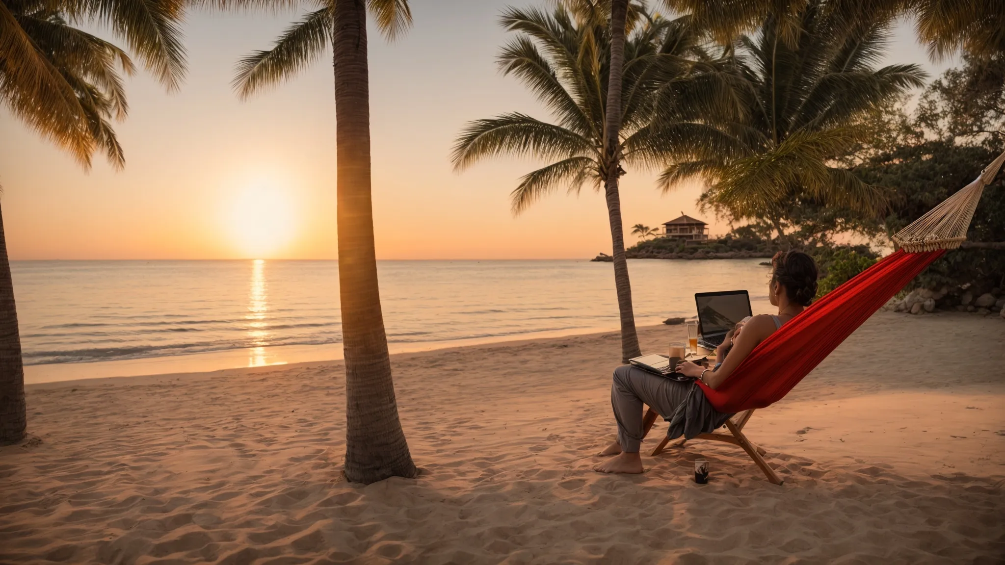 a marketer relaxing in a hammock with a laptop nearby, overlooking a serene beach sunset.
