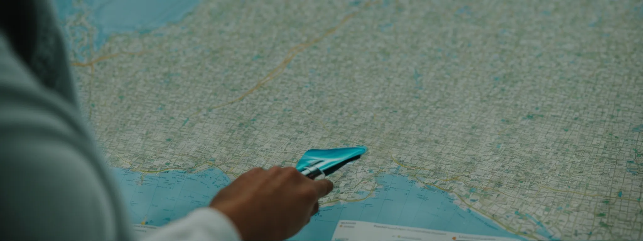 a doctor examines a local area map pinpointing medical facilities while a computer displays orthopedic practice search results.