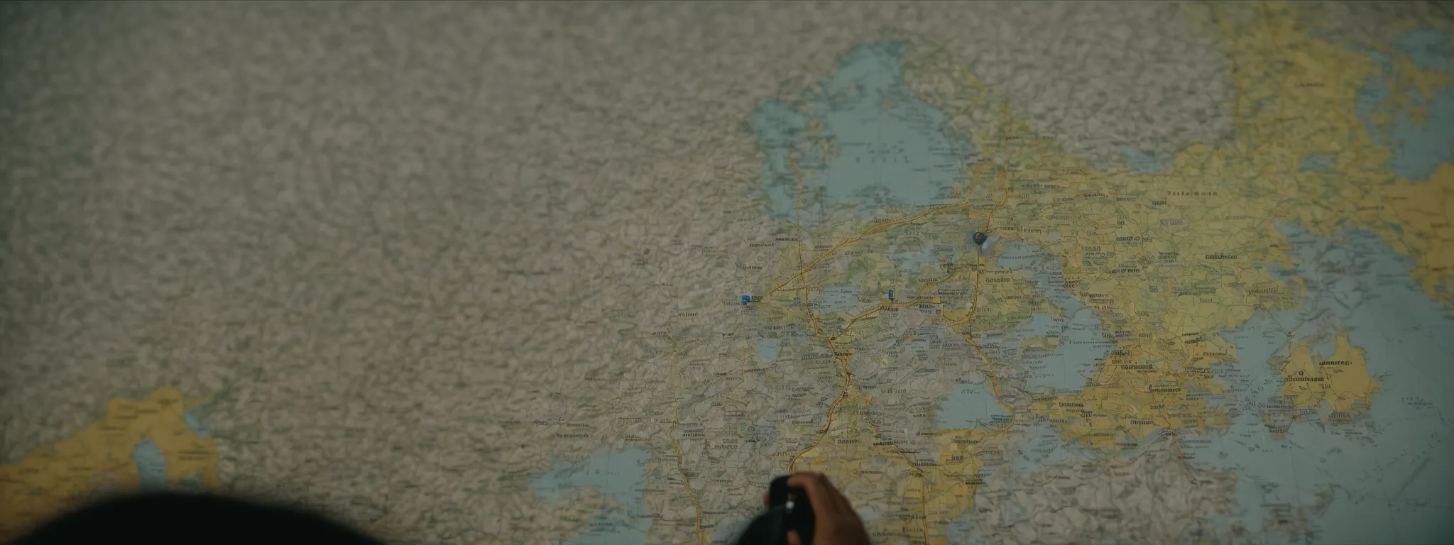a person contemplating a map dotted with various connected routes and domain landmarks.