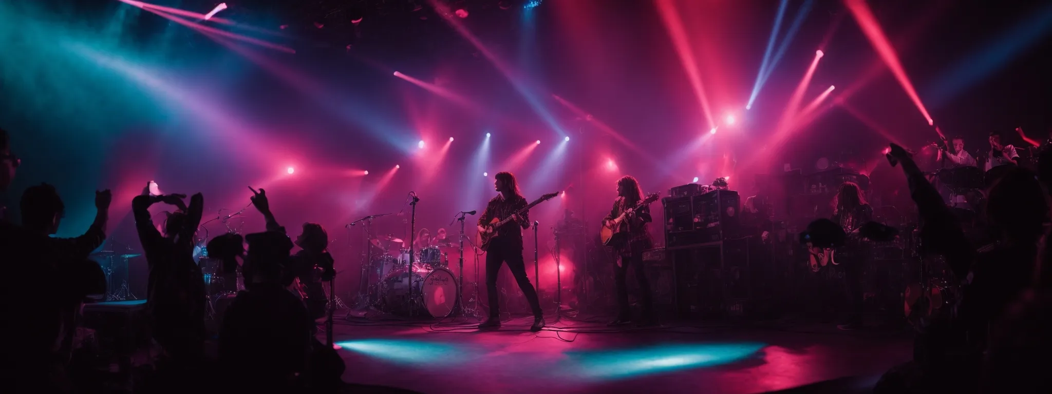 a band energetically performs on stage, immersed in a vibrant light show.