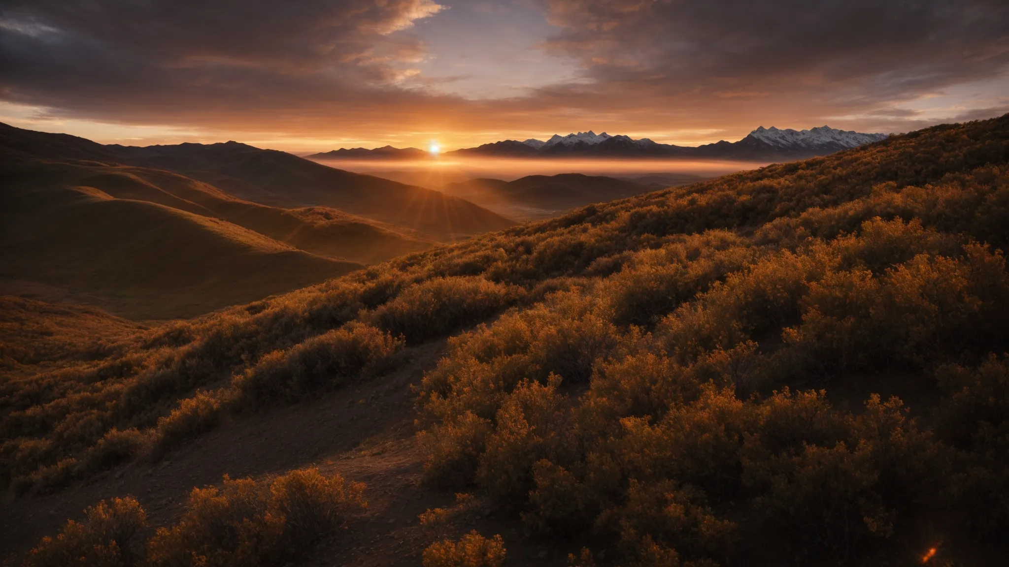 a golden sunset silhouetting a vast mountain range.
