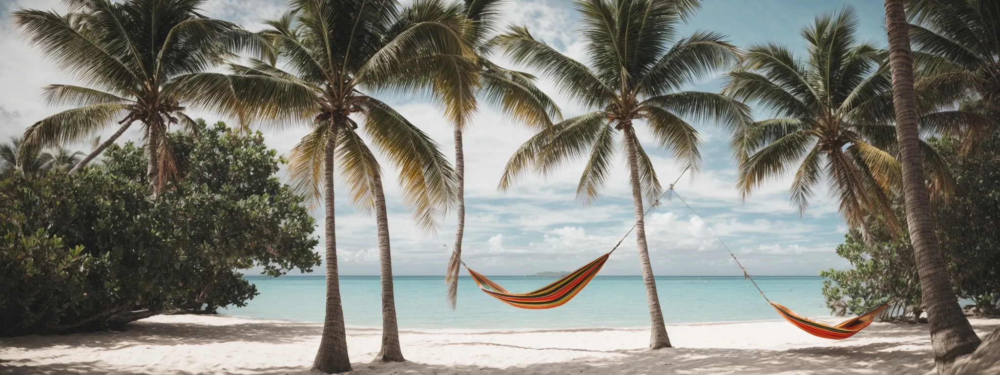 a serene beach with a hammock strung between two palm trees, symbolizing rest and relaxation.