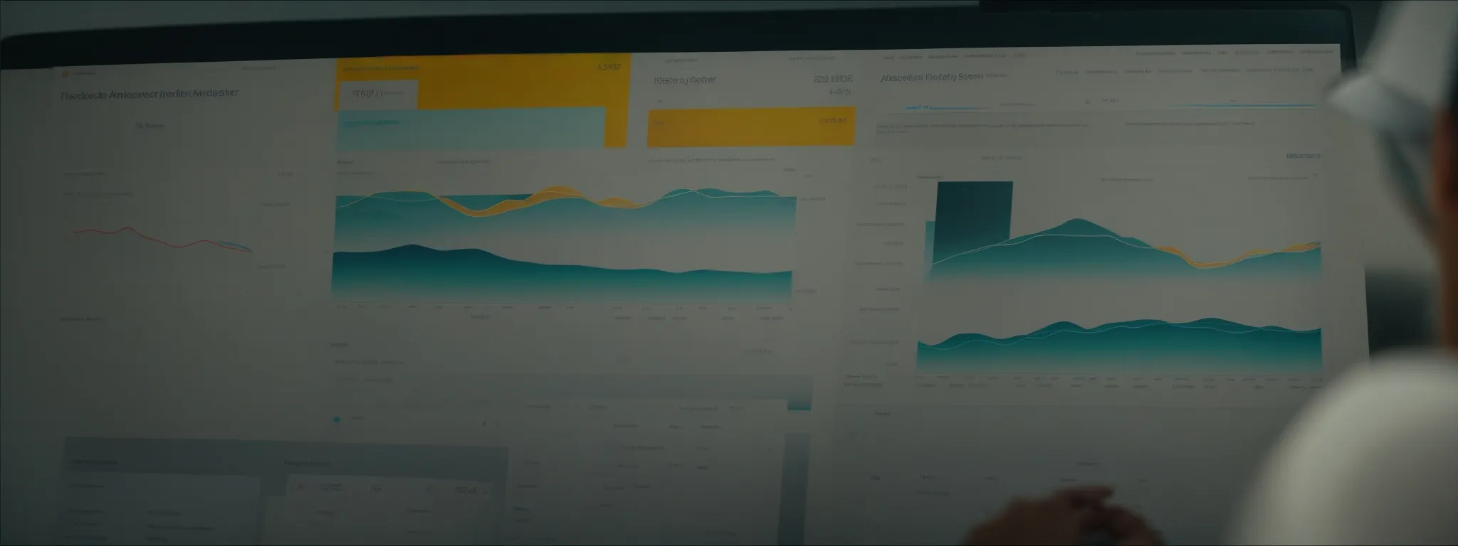 a person intently studies a dashboard on a computer screen displaying website traffic analytics.