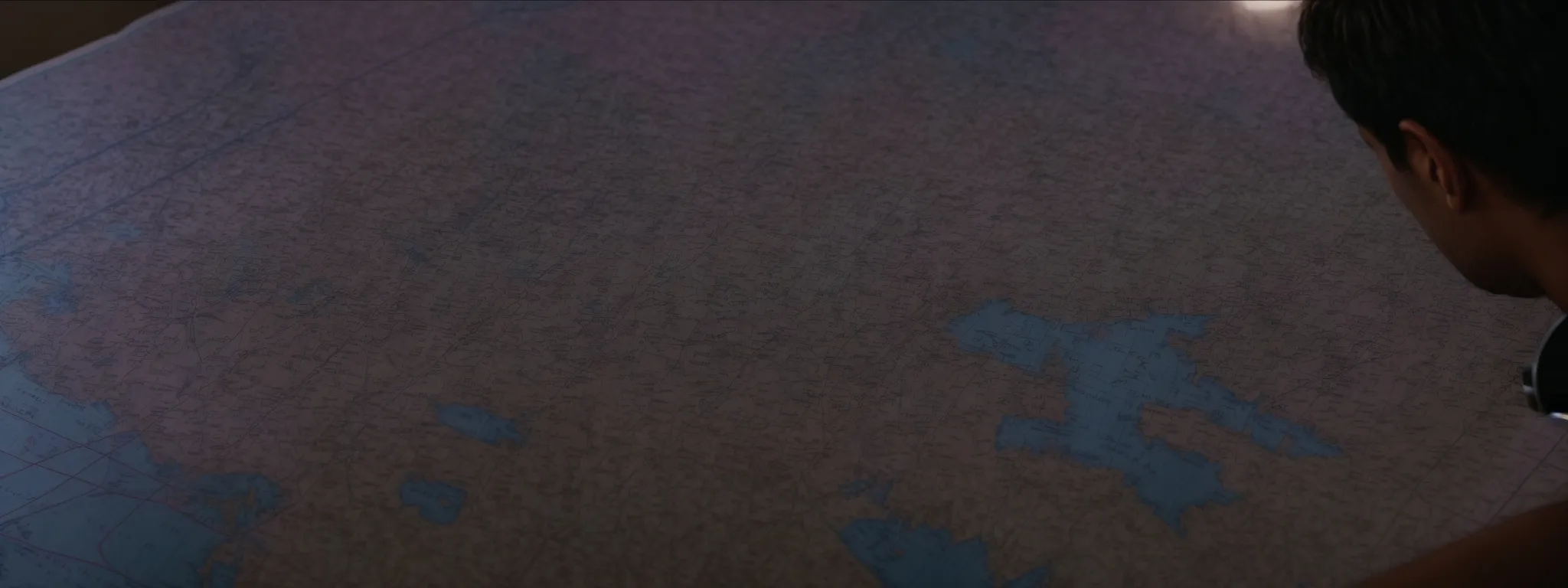 a doctor examining a navigational map laid out on a table, highlighting the strategic journey through a complex maze.