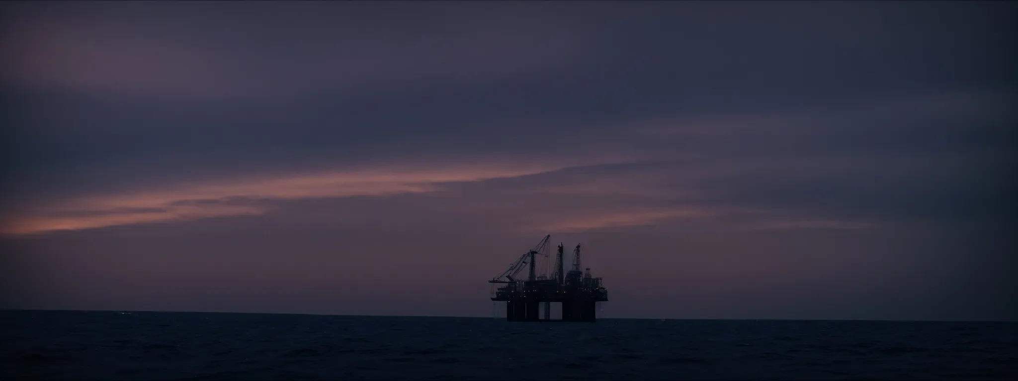 an oil rig silhouetted against a dusky sky, symbolizing the power and reach of the oil and gas industry in the digital marketing landscape.