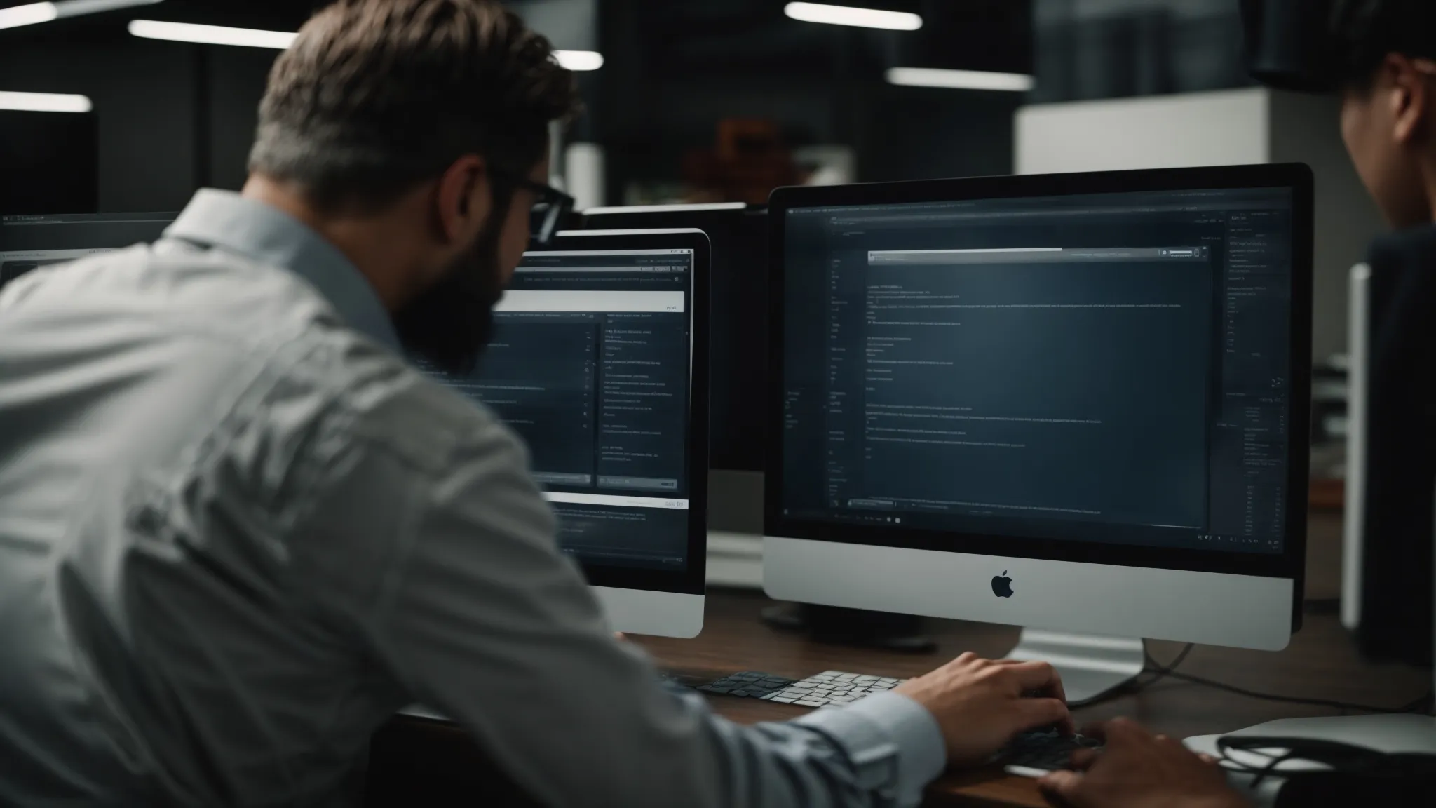 a seasoned professional points at a computer screen, showing an aspiring marketer the intricacies of a search engine results page.