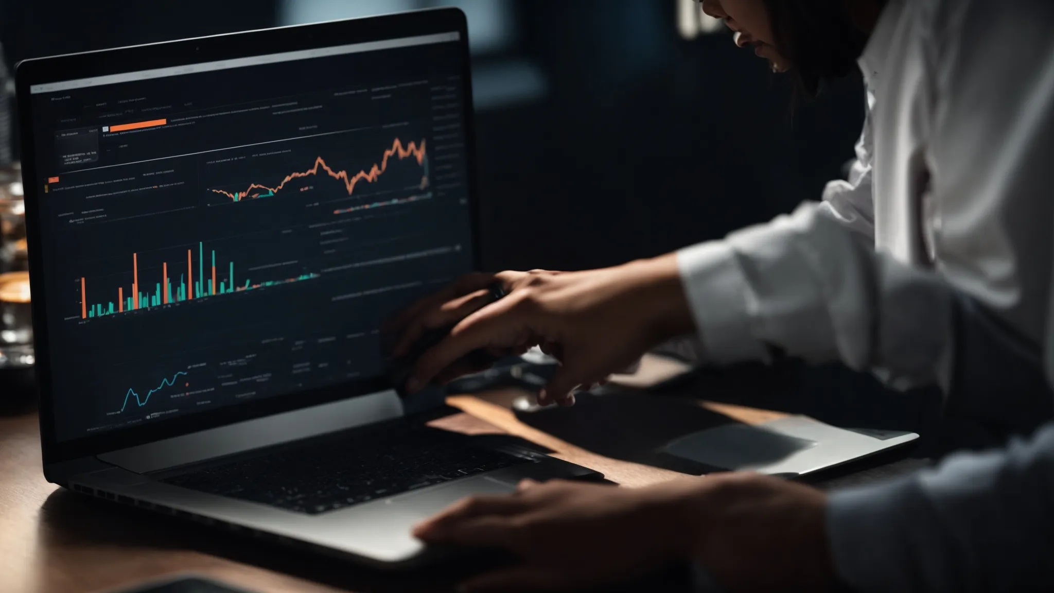 a person working on a laptop with graphs and charts visible on the screen, symbolizing website optimization strategies.