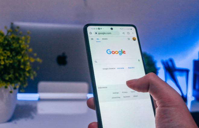 a person will make a Google search on a smartphone about how to use PPC data for SEO